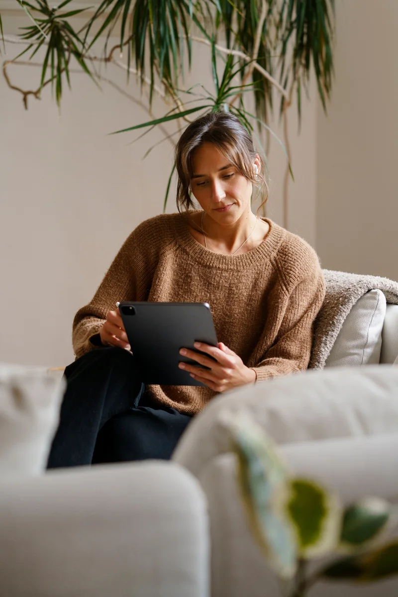 A woman completing an online consultation from home